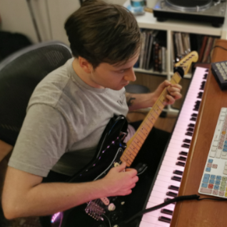 Rory Butler recording guitar in a studio